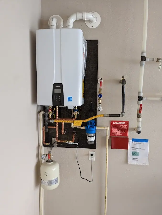 Professional plumber installing copper piping in a Cumberland home